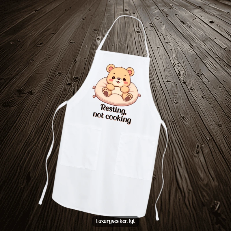 Funny apron showcasing a delighted bear lounging on a velvet cushion, perfect for adding humor to kitchen activities and as a gift.