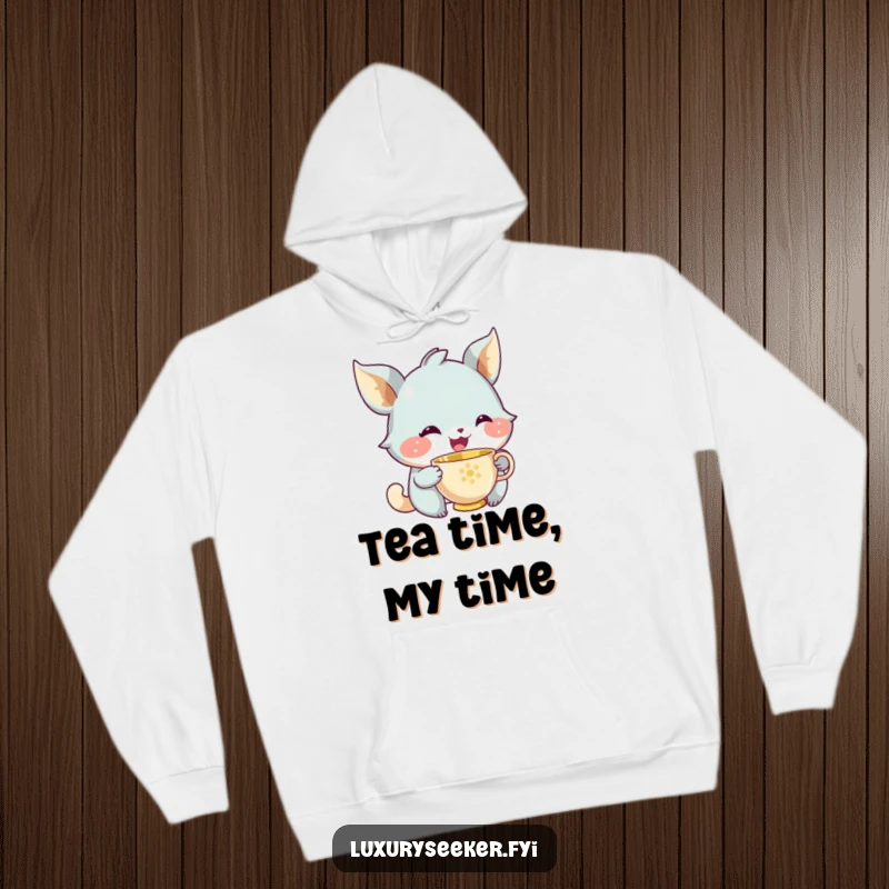 Funny hoodie print of a joyful creature with a subtle, knowing smile gently sipping from a miniature golden teacup, exuding peace.