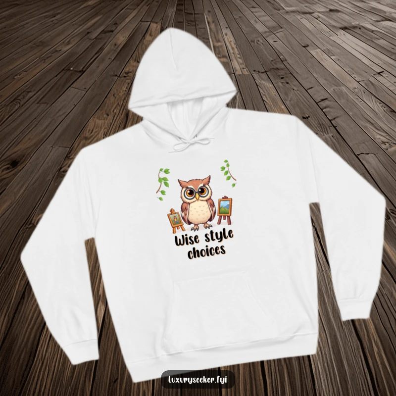 Funny hoodie with a wise owl wearing a monocle, overlooking a miniature art gallery, blending comfort with intellectual humor.
